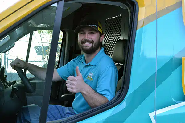SBC tech inside of fleet truck smiling giving a thumbs up in Shreveport LA.
